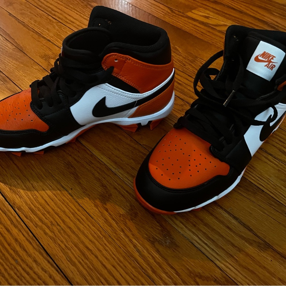 Brand new Nike Kids' Orange, Black, and White cleats